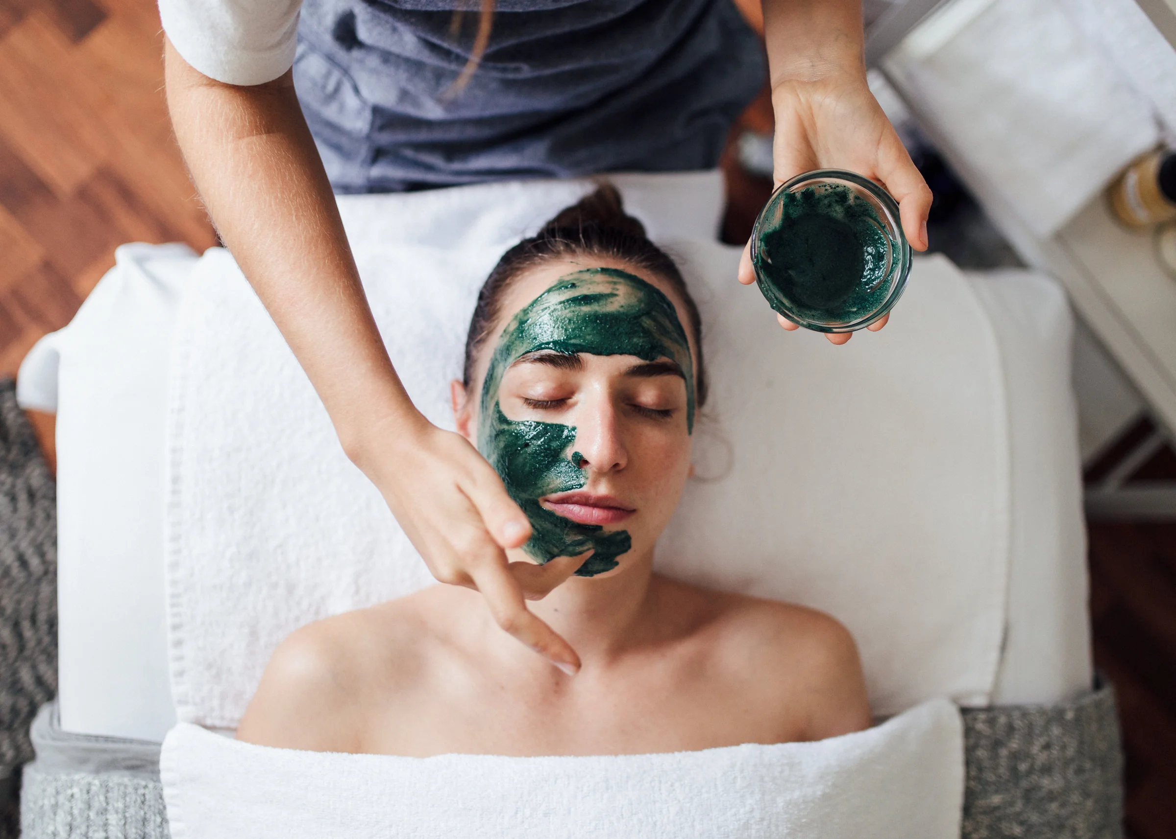 A photo of facial clay being applied.