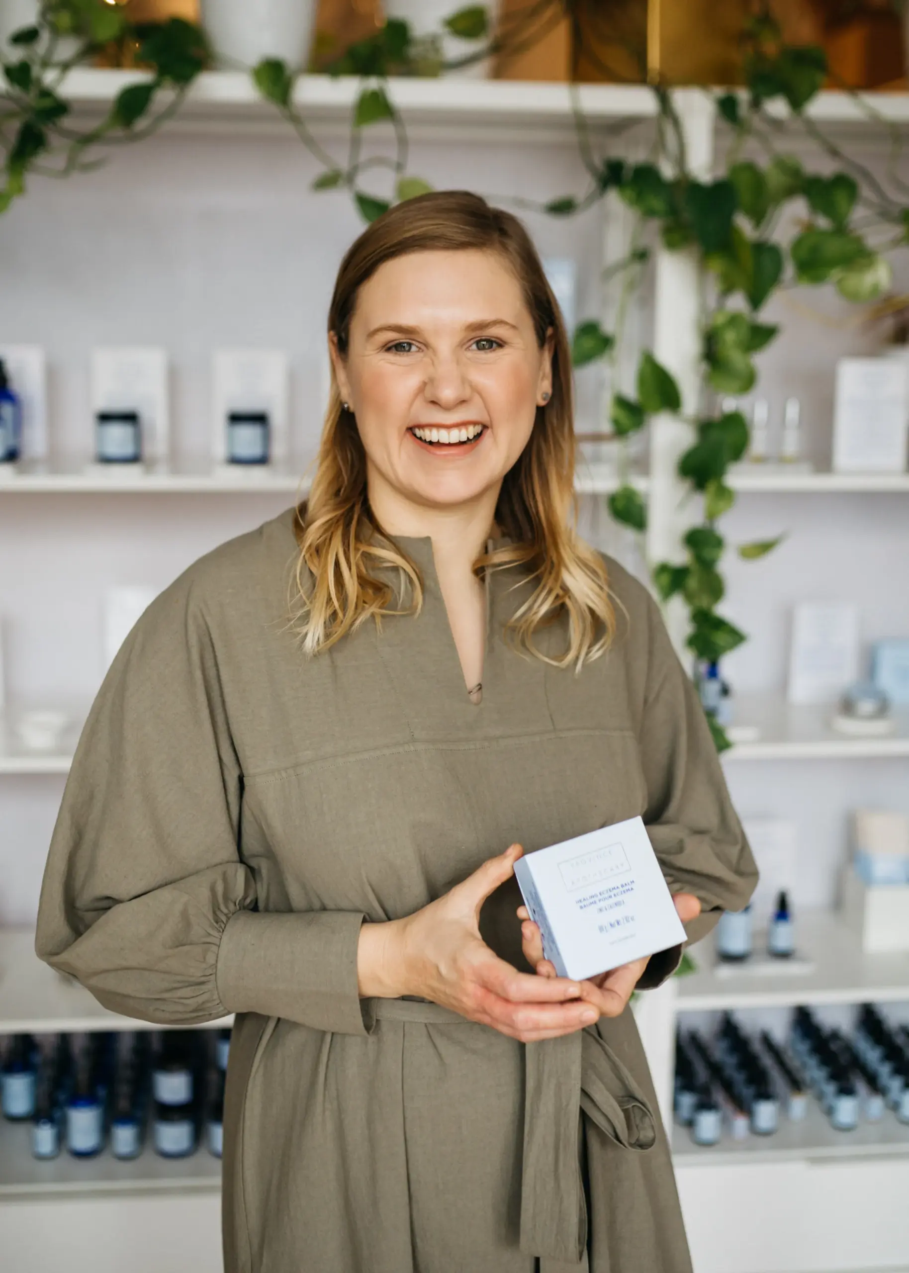 A photo of Julie Clark holding a product box.