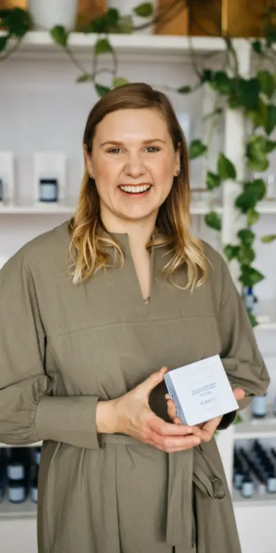 A photo of Julie Clark holding a product box.