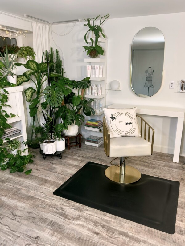 A photo of the salon showing a lounge chair and mirror.